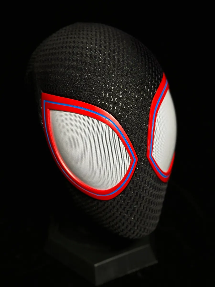 MaskOryx Miles Edition full head cosplay mask with black textured fabric, structured shell, and red-rimmed white lenses.