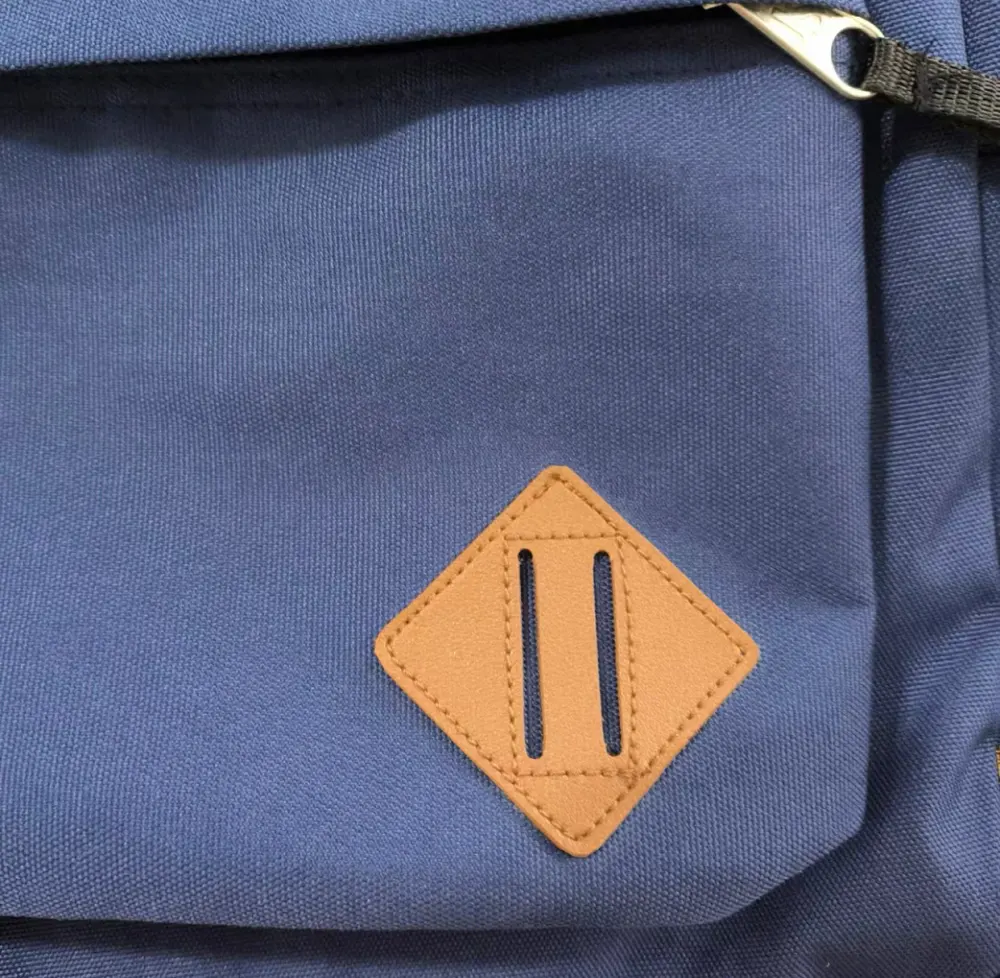 MaskOryx navy blue Peter Parker TASM1 replica backpack featuring a tan diamond-shaped lash tab detail
